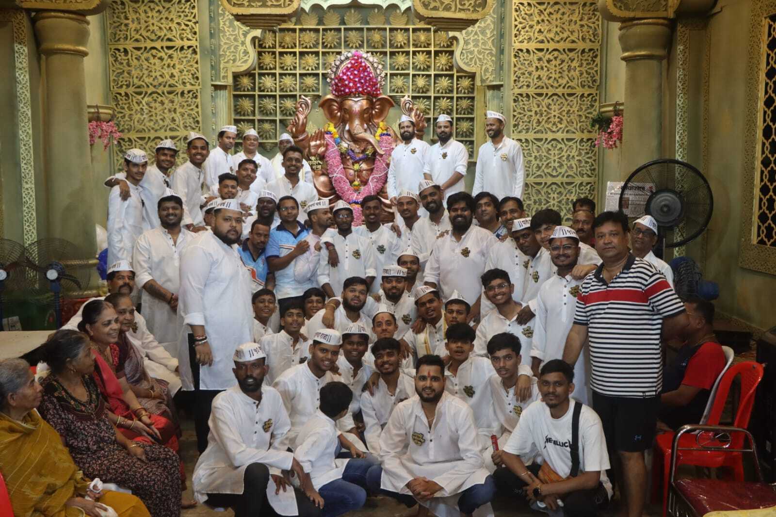 Grand Ganpati pandal with illuminated idol and devotees